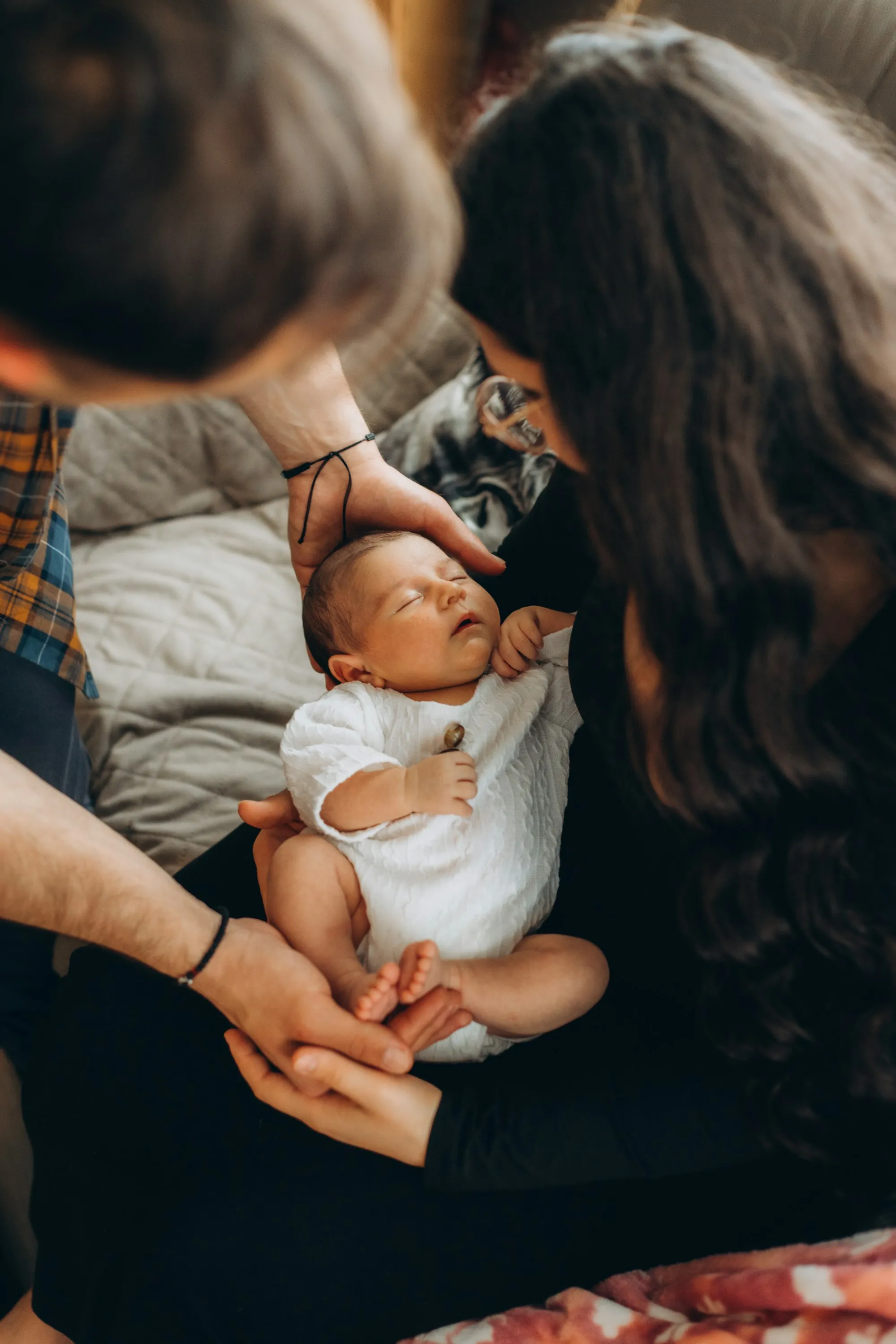 Newborn baby resting on a parent's lap